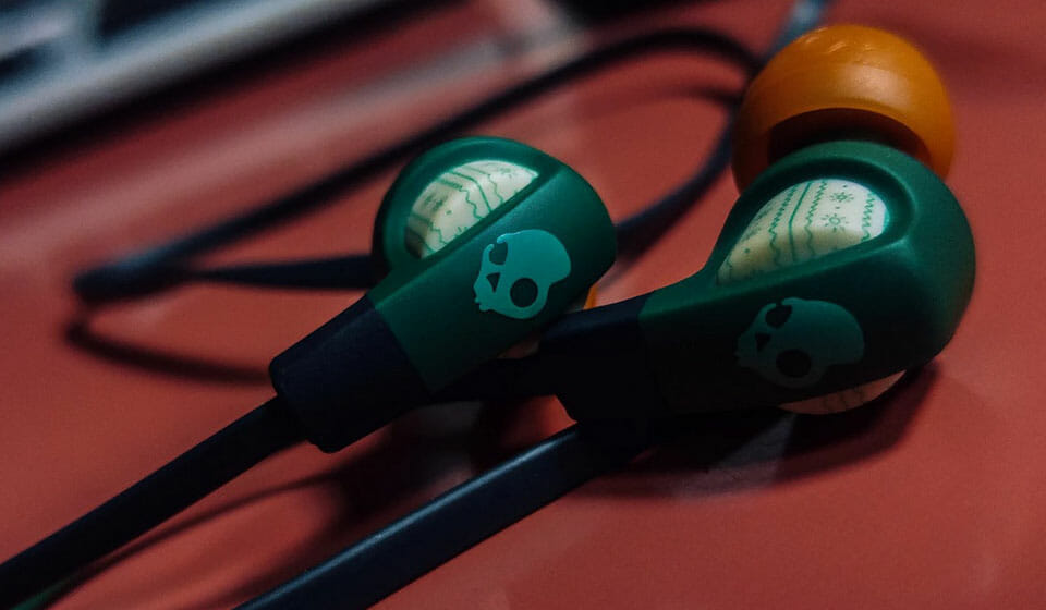 Skullcandy green and orange earbuds